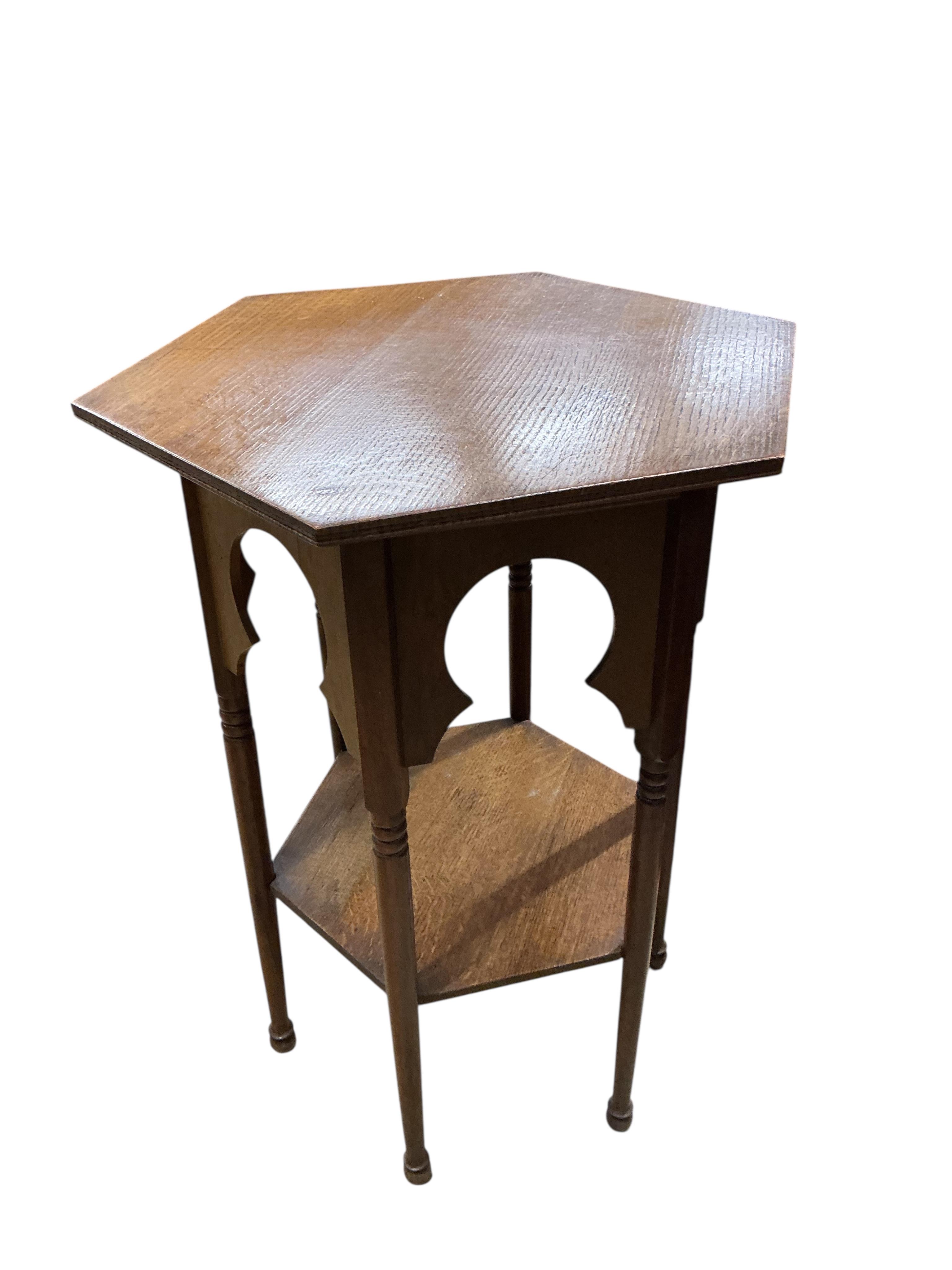 A pair of early 20th century Liberty style hexagonal oak two tier occasional tables, width 48cm, height 71cm